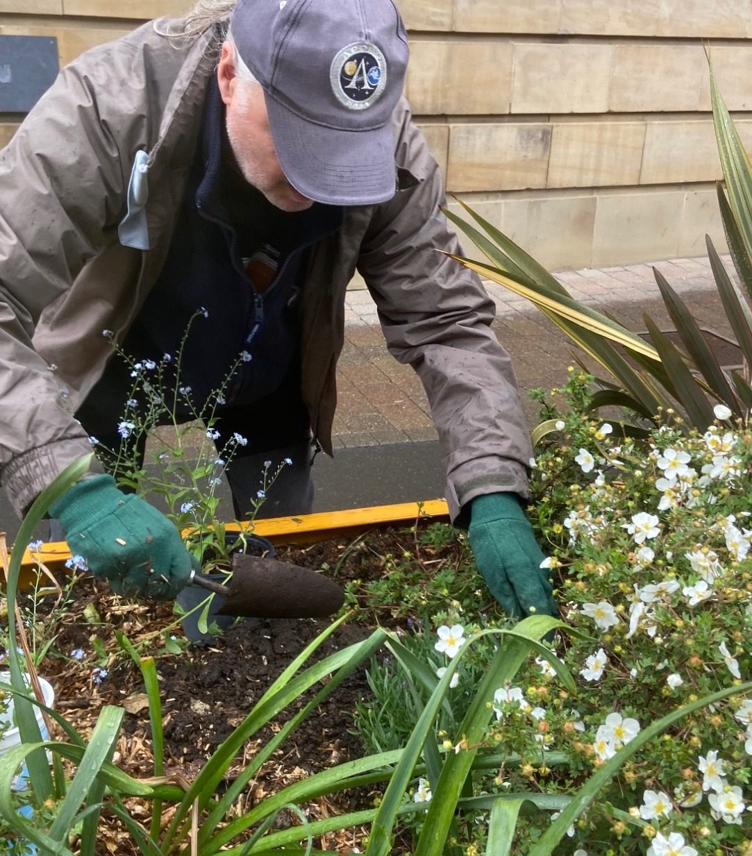 Blooming marvellous
on this damp May Day the
Friends of Castleford library planting to brighten up the flower tubs outside the library.