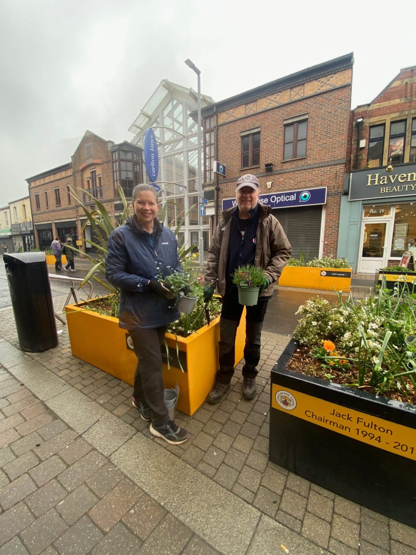 Blooming marvellous
on this damp May Day the
Friends of Castleford library planting to brighten up the flower tubs outside the library.